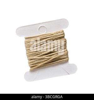 Beige embroidery thread on white  paper bobbin isolated cutout on white Stock Photo
