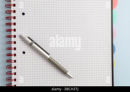Open blank spiral bound squared notebook and pen. High quality photo Stock Photo