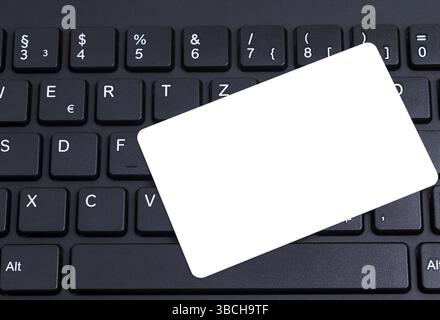 Black keyboard with a blank white pastiche card Stock Photo