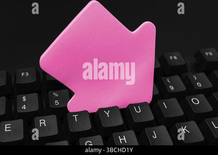 Colored sticker lying on keyboard. Important message written over paper Stock Photo