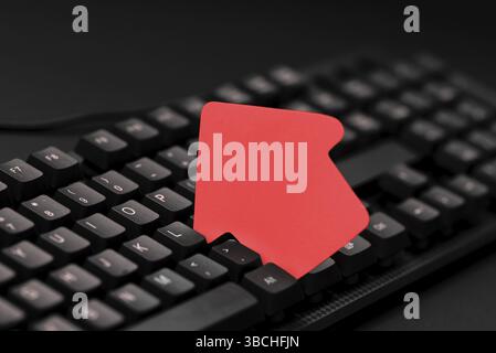Colored sticker lying on keyboard. Important message written over paper Stock Photo