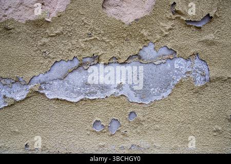 Old weathered brick wall with cracked plaster and peeling surface  Old weathered brick wall with cracked plaster and peeling surface Stock Photo