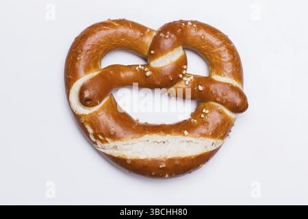 The photo shows a fresh pretzel against a white background Stock Photo