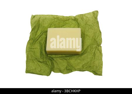 Bar of soap on green paper wrapper on white background Stock Photo