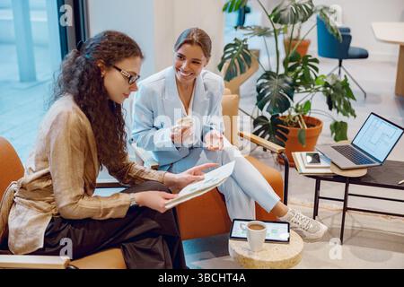 An Engaging Collaborative Meeting Taking Place in a Modern Workspace with Two Professionals Present Stock Photo
