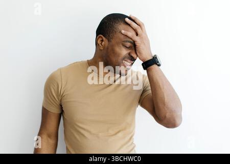 Young Black Man Doing Facepalm Gesture While Standing Isolated Over White Background Stock Photo