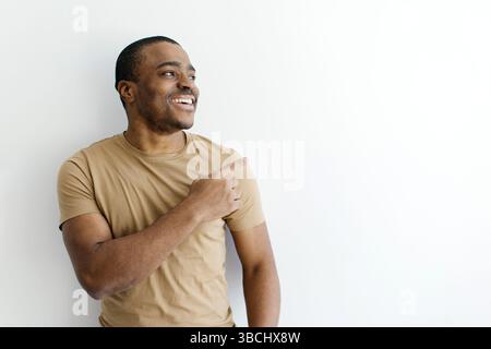 Look There. Cheerful Young African American Man Pointing Finger Aside Stock Photo