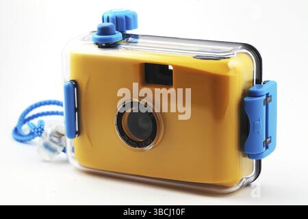 Yellow camera in waterproof box over white Stock Photo