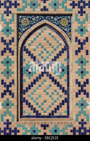 Intricate geometric patterns adorn Bibi-Khanym’s facade, visible amid Samarkand’s urban landscape in Uzbekistan, reflecting rich tradition. Stock Photo