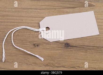 Image shows a blank label on a wooden table Stock Photo