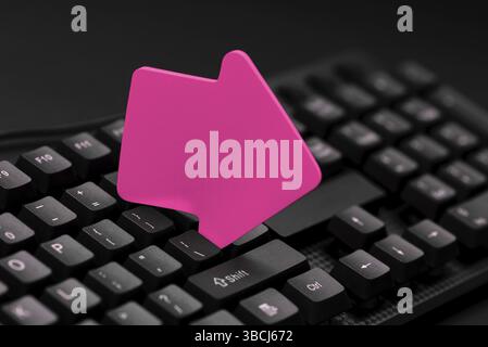 Colored sticker lying on keyboard. Important message written over paper Stock Photo
