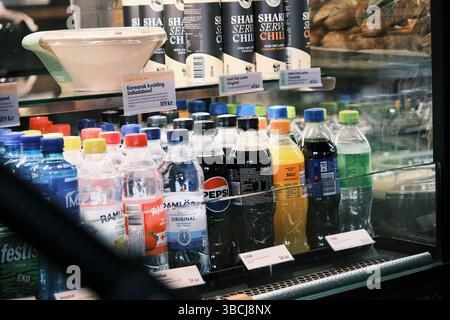 Stockholm, Sweden - April 5, 2025: A display of soda bottles in a store. The bottles are of different colors and sizes. Stock Photo