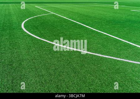 Soccer white marking lines of the Penalty arch area on artificial synthetic green grass turf Stock Photo