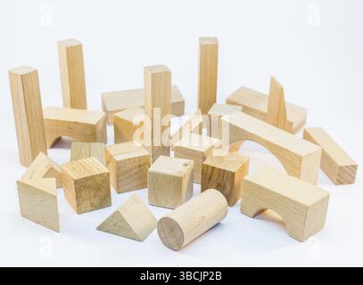 Different shapes of wooden building blocks for construction isolated on white background Stock Photo