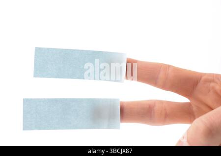 Male hand with two blue sticky notes on a white background Stock Photo