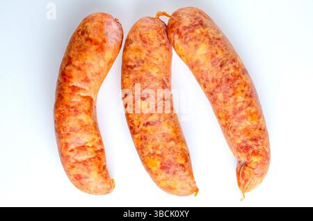Three raw smoked sausages on white background in studio lighting for food packaging, advertising, and culinary use Stock Photo