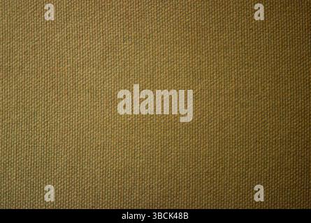 Close-up of a rustic woven fabric with natural fibers and visible texture in earth tones Stock Photo