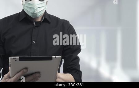 Close up of a businessman with a medical protection mask on a corridor in a hospital Stock Photo