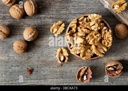 Ripe and fresh walnut kernels in bowl without shell on rustic table, healthy nut food for brain Stock Photo