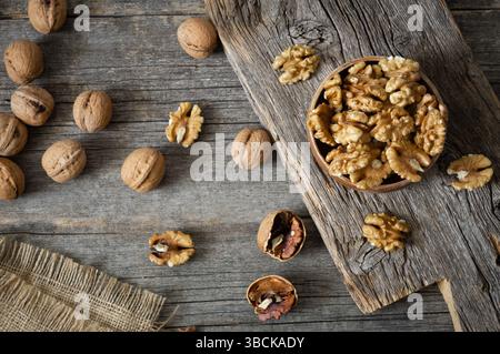 Ripe and fresh walnut kernels in bowl without shell on rustic table, healthy nut food for brain Stock Photo