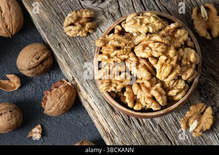Ripe and fresh walnut kernels in bowl without shell on rustic table, healthy nut food for brain Stock Photo