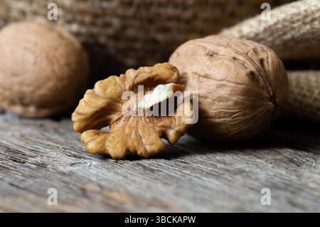 Close up ripe and fresh walnut kernel without shell on wooden rustic table, healthy nut food for brain Stock Photo