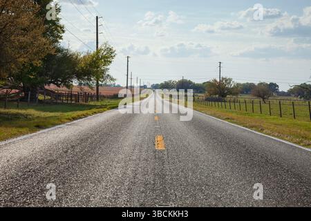 Low angle view of two lane asphalt highway in rural central Florida on a sunny afternoon Stock Photo