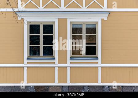 View of two rectangular windows with white frames against a beige colored wooden wall. From the windows of the world series. Stock Photo