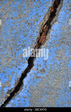 Large cracked concrete surface. Deeply cracked, broken, damaged old wall Stock Photo