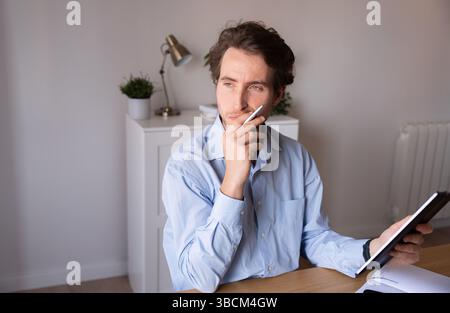 Focused professional managing his schedule in an office environment Stock Photo