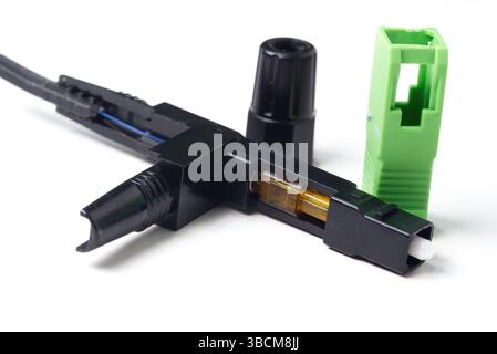 fiber optic cable connector open showing the fiber optic connection on white background Stock Photo