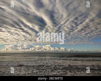 Dramatic Cloud Formation Over the Ocean with Sunlight Breaking Through Stock Photo