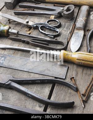 Old and rusty tools on a rustic wooden table Stock Photo
