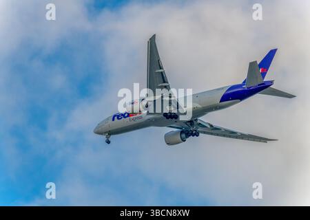 FedEx Express Boeing 777-FS2 cargo plane is unloaded, air freight