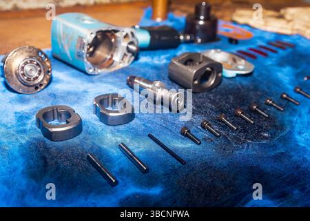 Disassembled pneumatic tool on the table. Pneumatic impact wrench. Stock Photo