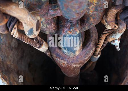 Rusty anchor chain on a ship in an anchor hawsepipe close-up. Stock Photo