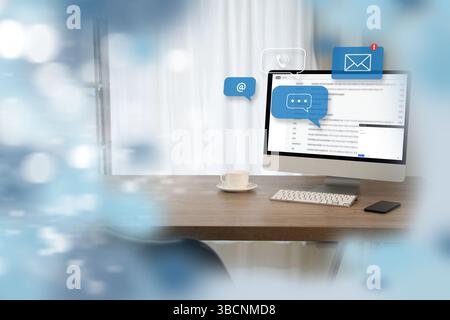 A contact us modern workspace with desktop computer displaying email and messaging icons, coffee cup, and smartphone wooden desk, with blurred Stock Photo