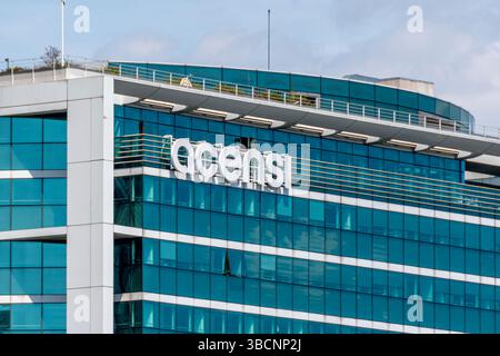 Sign and logo on the building housing Acensi's headquarters. Acensi is a company specializing in IT project management and digital services Stock Photo