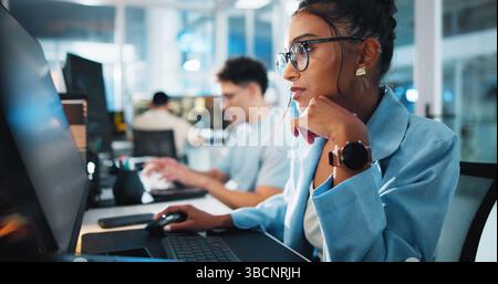Computer, programmer and thinking with woman in office for game designer, coding idea and ux update. Software development, reflection and level Stock Photo