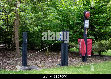 A water tap, electric hook up and fire point in a forest campsite Stock Photo