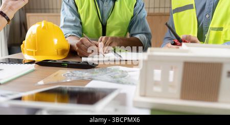 Sustainable Design Discussion. Engineers collaborating on innovative renewable energy projects in an office. Stock Photo