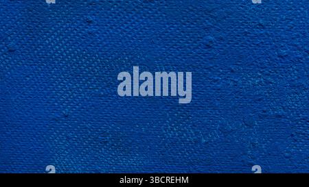 Close-up of a textured wall with deep blue paint, showing subtle brush marks and surface imperfections Stock Photo