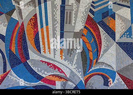 Colorful abstract mosaic with geometric shapes in blue, orange, red, and gray tiles, ideal for backgrounds, art, and creative design projects. Stock Photo