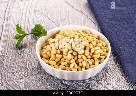 Delicous Peeled cedar nut in the bowl Stock Photo