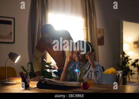 Enjoying Study Session with Family Helping in Evening Stock Photo