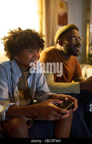 Smiling Father and Son Playing Video Games Together Stock Photo