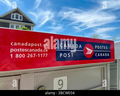 East Gwillimbuty, Ontario, Canada - May 20, 2025: Canada Post residential neighbourhood community mail box with blue sky Stock Photo