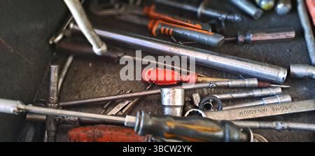 Chrome vanadium tools and various other tools laying messily in metal toolbox Stock Photo
