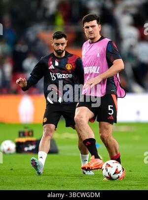Harry Maguire and Bruno Fernandes of Manchester United lift the Carabao
