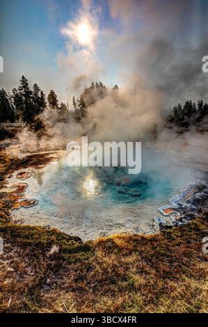 Geysers spew boiling water and steam into the air. Stock Photo